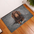 Dachshund entryway rug displayed beside a white door on a warm wood floor