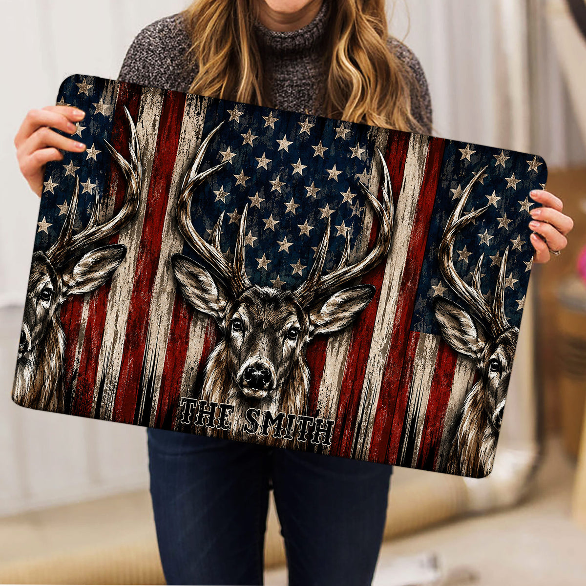 Deer and American flag hunting doormat held up for a detailed product view