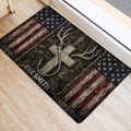 Hunting-themed door mat with antlers, bow, woodland artwork, and distressed flag details beside a doorway
