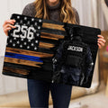 Police doormat held indoors showing a tactical law enforcement officer and distressed flag-inspired artwork