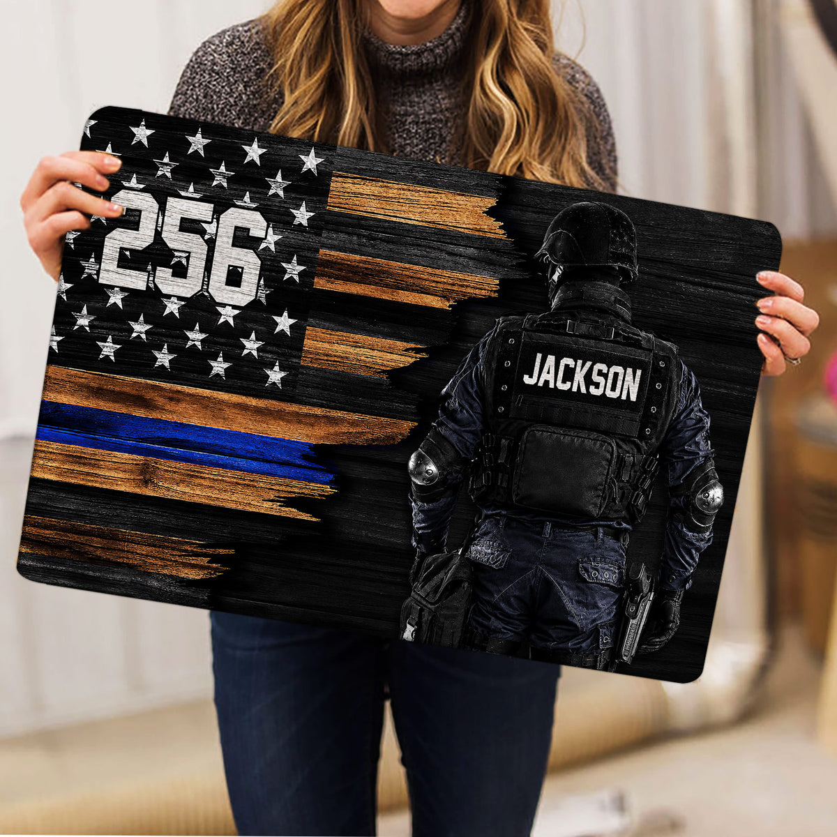 Police doormat held indoors showing a tactical law enforcement officer and distressed flag-inspired artwork