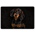 Black dachshund doormat featuring a realistic portrait and orange script accent on a dark background