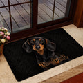 Dachshund entryway mat shown near a glass door with a dark realistic dog portrait