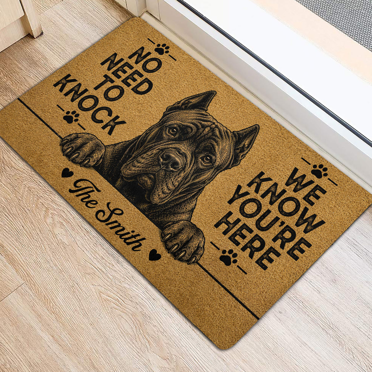 Cane Corso entryway mat shown near a door with a detailed dog portrait, paw prints, and bold black lettering