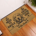 Golden Retriever entryway doormat displayed beside a white door on a wood floor
