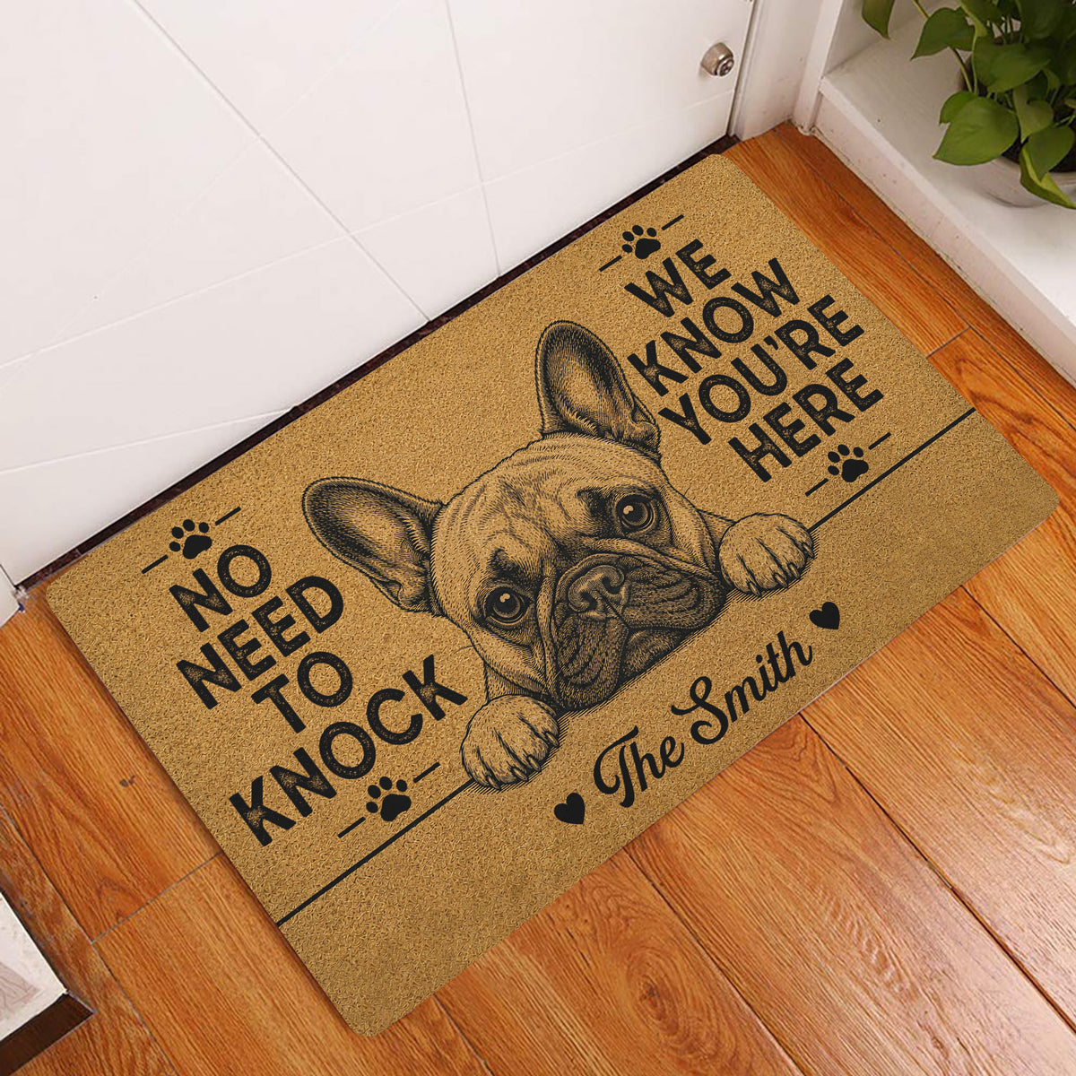 French Bulldog doormat styled in a home's entryway on hardwood flooring beside a white door