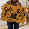 Person holding a tan French Bulldog doormat featuring a bold dog portrait, paw prints, hearts, and lettering