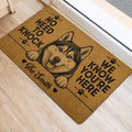 Husky door mat styled beside a doorway with bold black lettering and paw print details