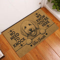 Goldendoodle doormat styled at an indoor entryway beside a white door and warm wood flooring