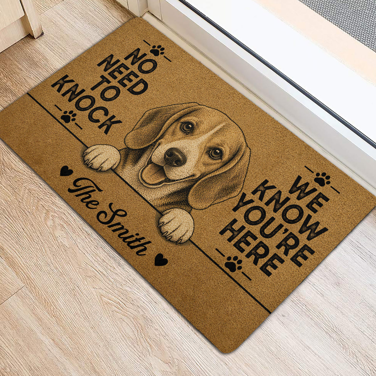 Beagle front door mat with paw prints and bold lettering on a light wood floor
