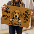 Person holding a brown beagle doormat featuring a cheerful dog portrait and paw prints