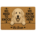 Custom family name Great Pyrenees doormat with fluffy white livestock guardian dog peeking over a black line, friendly smiling face, paw print icons, natural tan coir-look printed background and funny No Need to Knock We Know You’re Here quote.