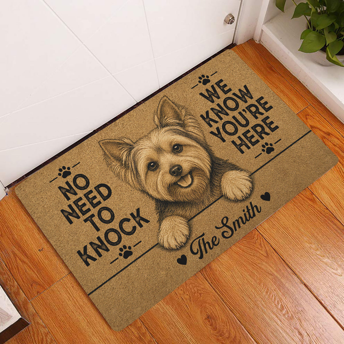 Yorkie entryway rug displayed by a white door on hardwood flooring with a happy dog portrait