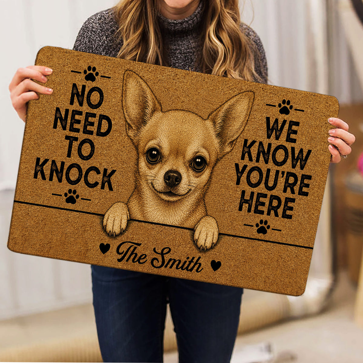Person holding a Chihuahua doormat featuring a detailed dog portrait, paw prints, hearts, and welcome lettering