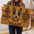 Person holding an Australian Cattle Dog doormat featuring a detailed portrait, paw prints and bold black lettering