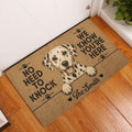 Dalmatian entryway rug displayed beside a white door on hardwood flooring