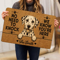 Person holding a Dalmatian doormat featuring a spotted dog illustration and paw print accents