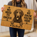 Curly Coated Retriever doormat held indoors, showing the detailed dog artwork, paw prints and bold welcome design