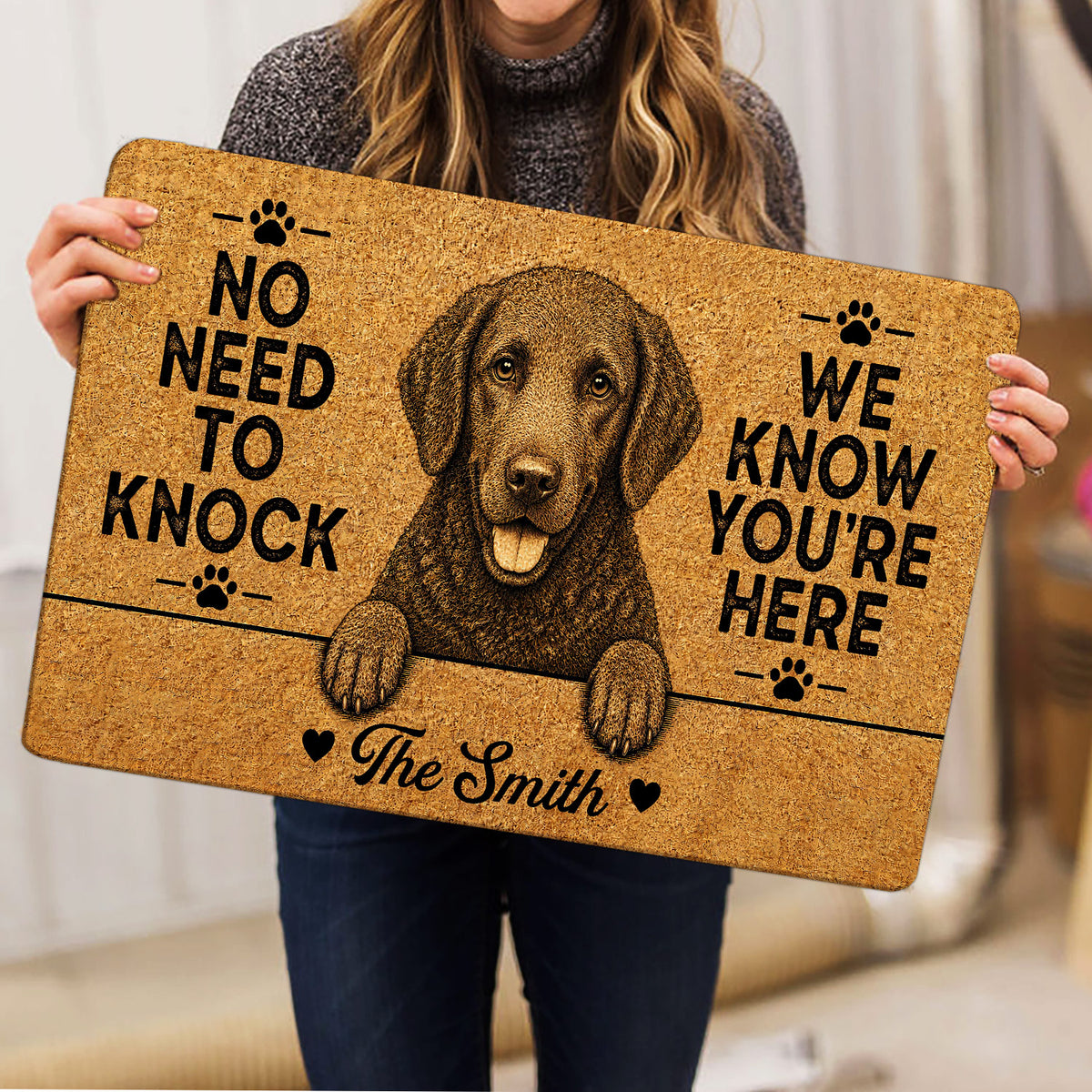 Curly Coated Retriever doormat held indoors, showing the detailed dog artwork, paw prints and bold welcome design