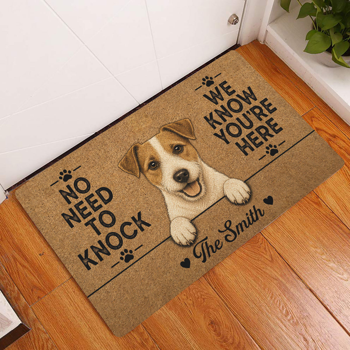Jack Russell terrier entryway doormat displayed beside a white door on a hardwood floor