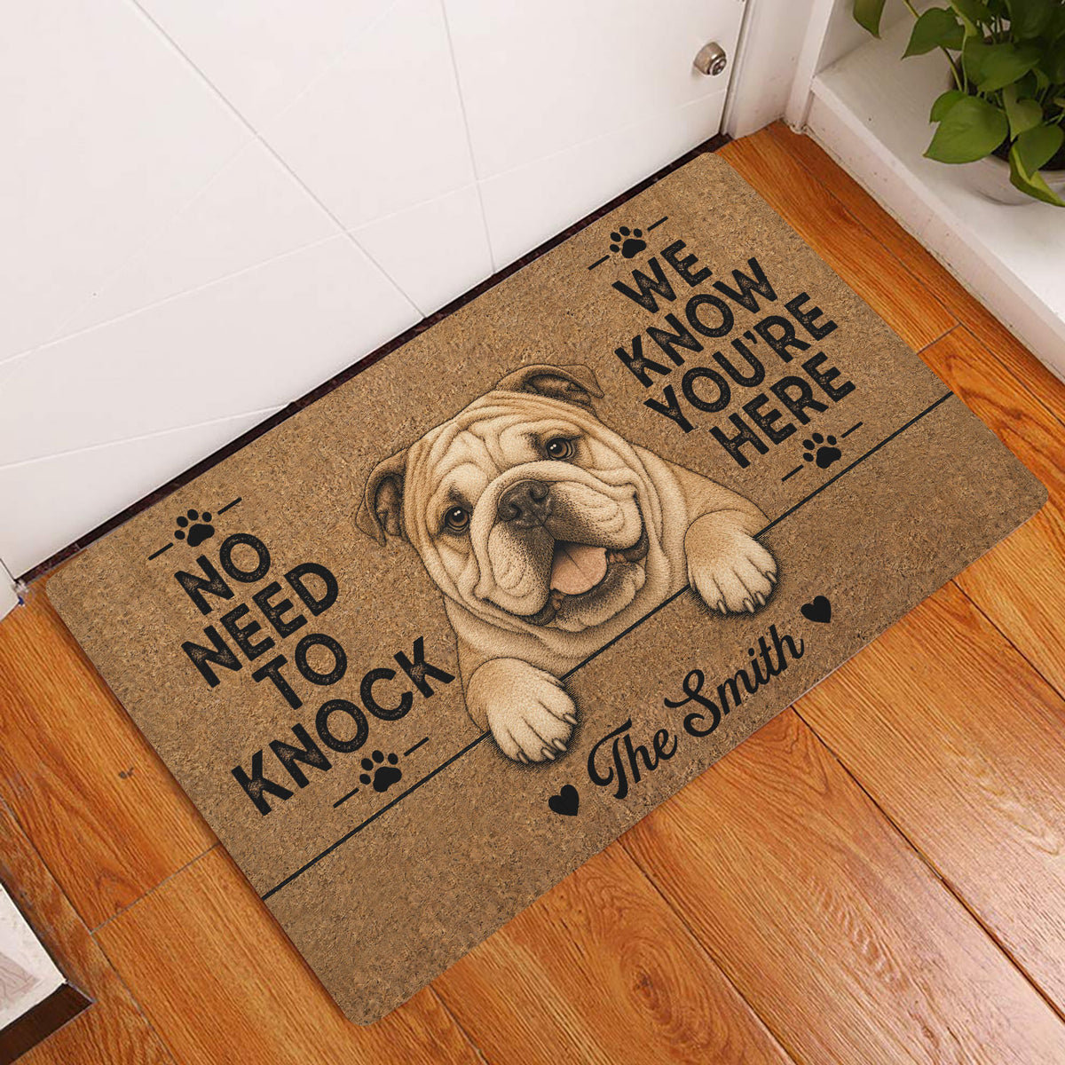English Bulldog entryway mat displayed beside a white door on a warm wood floor