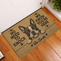 Boston Terrier entryway doormat displayed on a wood floor beside a white door with bold paw-print artwork