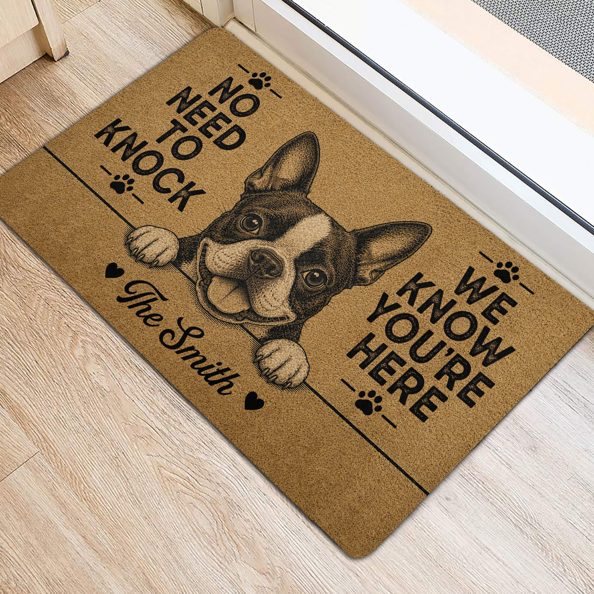 Boston Terrier door mat positioned by an entrance, featuring a playful dog illustration, paw prints, and bold lettering