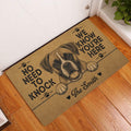 Boxer dog entryway mat displayed beside a white door on a warm wood floor