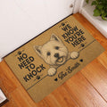 Westie doormat displayed in a wood-floor entryway beside a white door with a playful terrier design
