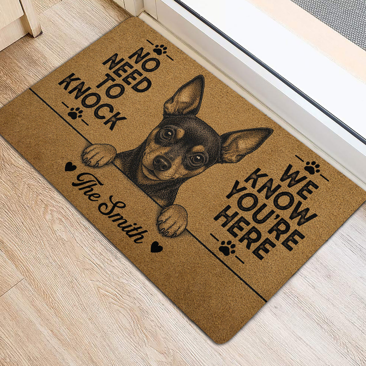 Miniature Pinscher door mat styled at an entryway with black artwork and paw print accents