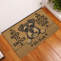 Miniature Schnauzer doormat displayed at a home entrance on a warm wood floor