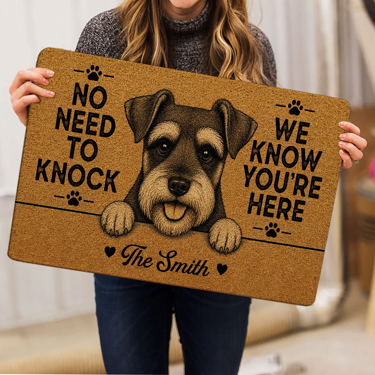 Person holding a tan Miniature Schnauzer doormat featuring a detailed dog portrait and paw print accents