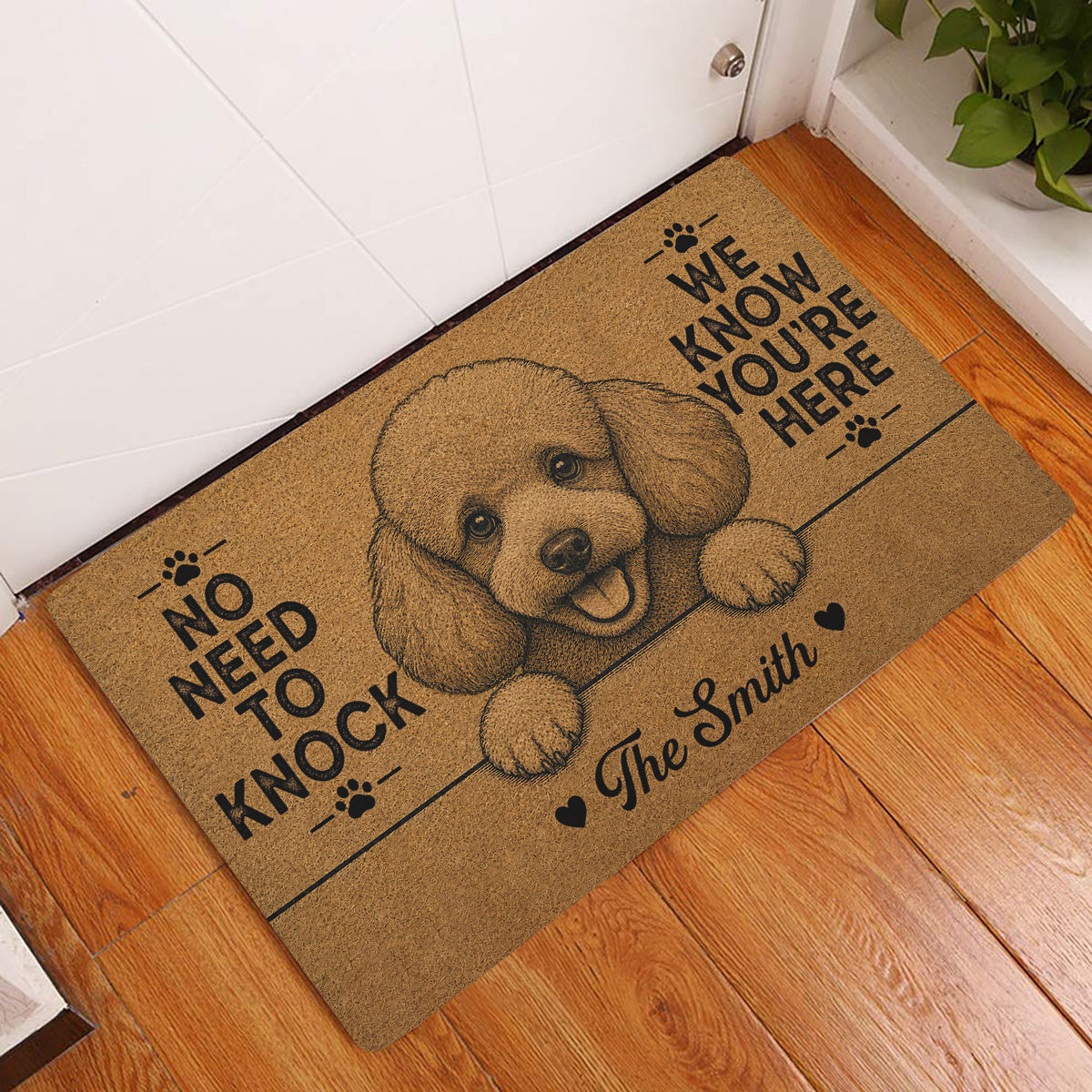 Poodle welcome doormat displayed in a home entryway on warm wood flooring