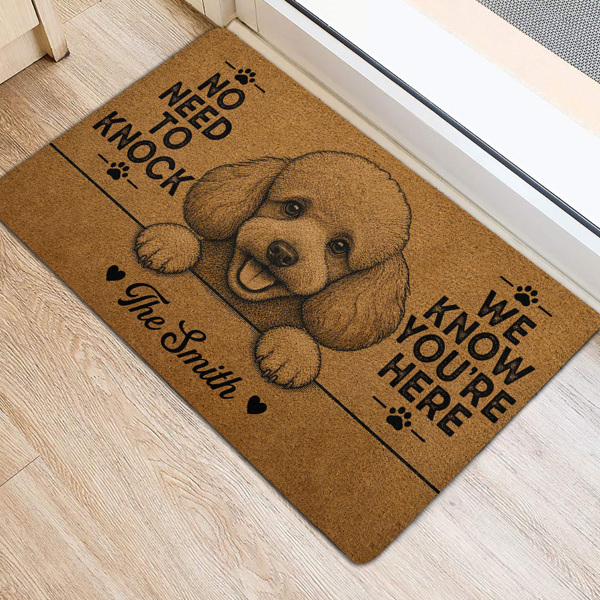 Poodle door mat positioned beside a doorway on light wood flooring with playful paw-print artwork