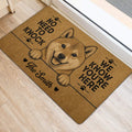 Shiba Inu door mat beside an entrance with playful paw-print artwork and welcome lettering