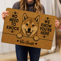 Person holding a Shiba Inu doormat featuring a cheerful dog illustration and paw-print design