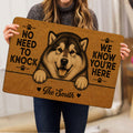 Alaskan Malamute door mat held indoors, showing the detailed dog portrait and paw print design