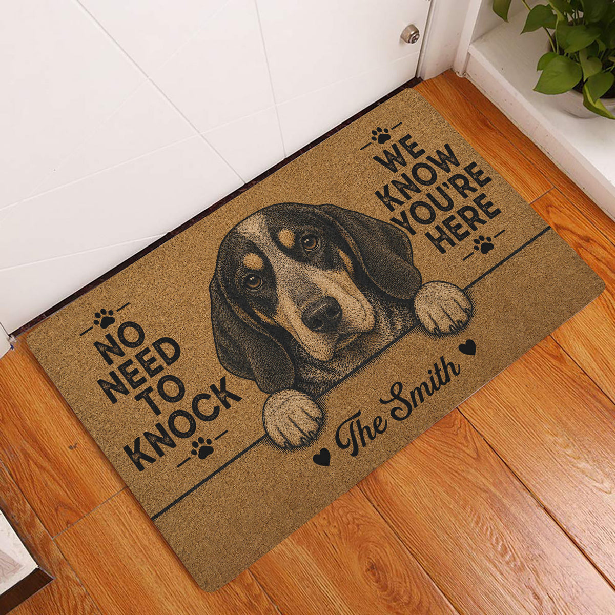 Bluetick Coonhound entryway mat displayed beside a white door on a warm wood floor