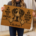 Person holding a brown Great Dane doormat with paw prints, hearts, and bold welcome lettering