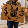 Person holding a Dutch Shepherd doormat with detailed dog artwork and paw print accents