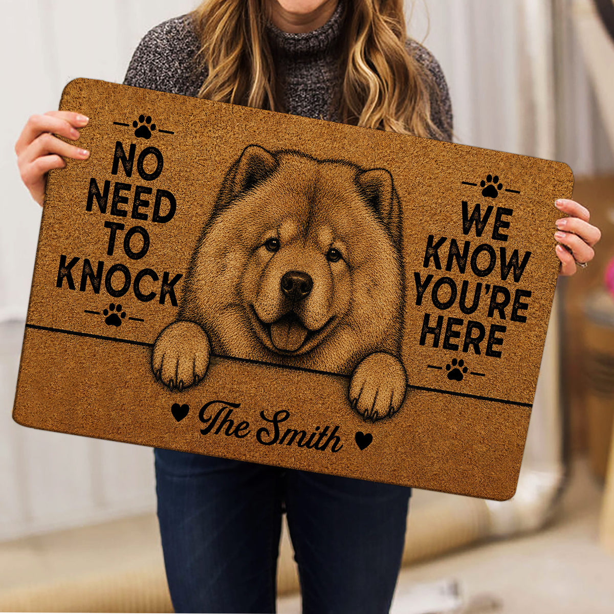 Person holding a brown Chow Chow doormat featuring a detailed dog portrait and playful welcome lettering