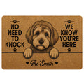 Tan Schnoodle doormat featuring a curly-haired dog portrait, paw prints and bold black entryway lettering
