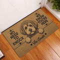 Schnoodle doormat displayed by a white entry door on a warm wood floor