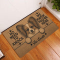 Papillon dog entryway rug displayed beside a white door on a warm wood floor