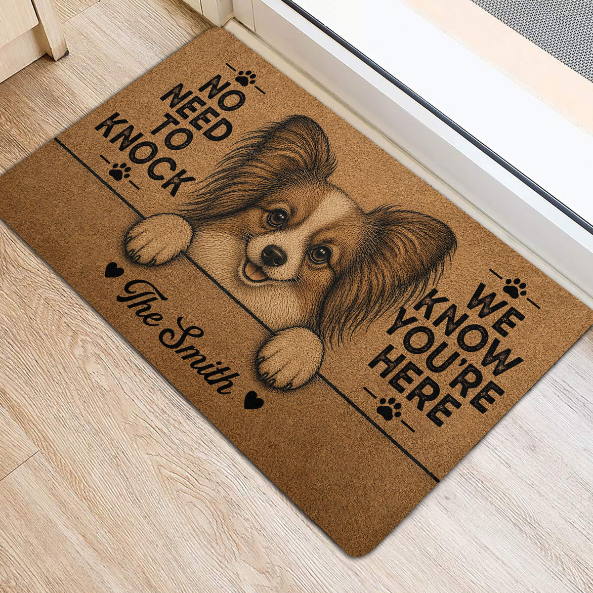Papillon dog door mat shown at a home entrance with portrait artwork and paw prints
