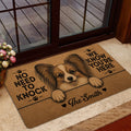 Papillon dog welcome mat styled inside a doorway near a deck and floral arrangement