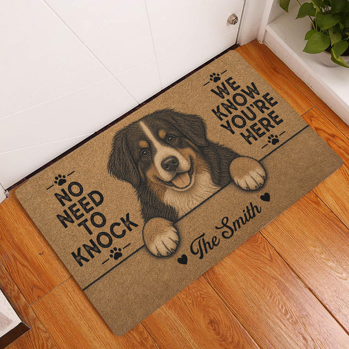 Bernese Mountain Dog entryway mat displayed beside a white door on a wood floor