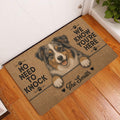Australian Shepherd entryway mat displayed beside a white door on a warm wood floor