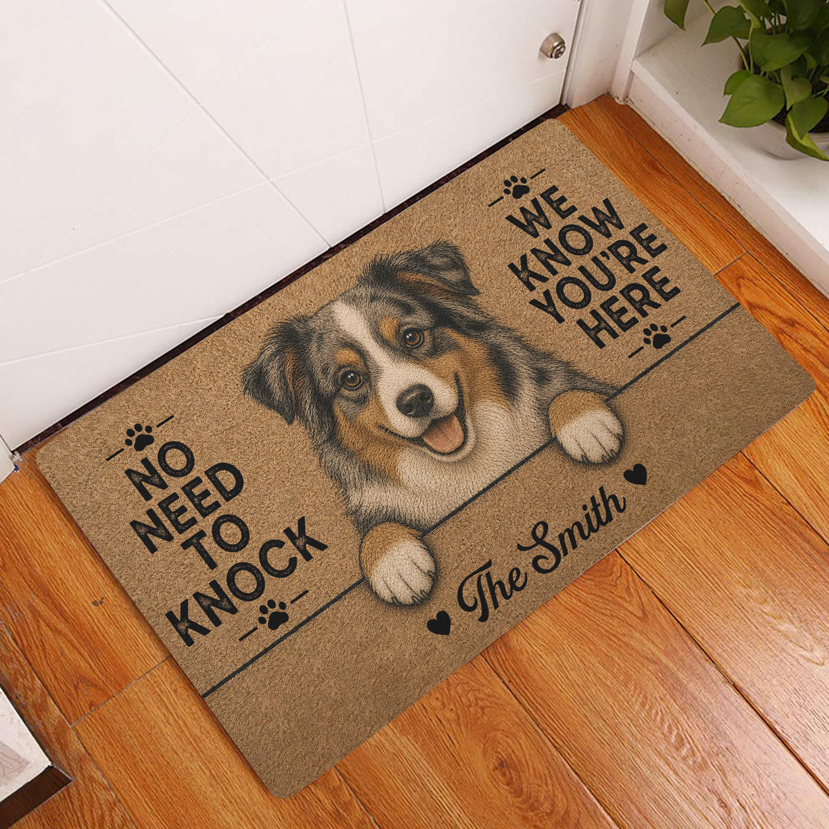 Australian Shepherd entryway mat displayed beside a white door on a warm wood floor