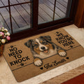 Australian Shepherd welcome mat displayed near a glass entry door with flowers and a home entrance setting